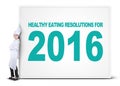 Chef leans on billboard of healthy eating resolutions Royalty Free Stock Photo