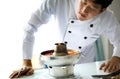 Chef looking and examining at the food, Tom yum goong, famous Thai spicy hot pot. Royalty Free Stock Photo