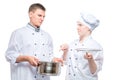 chef looks at a cooked dish of a young cook with a reproach on a white