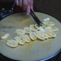 Chef makes banana crepe on hot pan