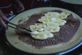 Chef makes chocolate banana crepe on hot pan at bangkok