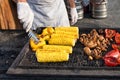 Chef making grilled vegetables outdoor on open kitchen international street food festival event. Royalty Free Stock Photo