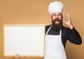 Chef man with empty menu. Cook with blank chalkboard with Copy space for text. Bearded baker with Advertising board