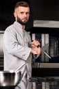 Chef man with knife at kitchen restaurant. Portrait of male cook sharp knife. Royalty Free Stock Photo