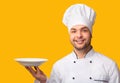 Chef Man Serving Dish Holding Empty Plate Over Yellow Background Royalty Free Stock Photo