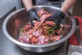 The chef marinates pork meat. Delicious food in the restaurant. Royalty Free Stock Photo