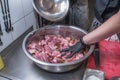 The chef marinates pork meat. Delicious food in the restaurant. Royalty Free Stock Photo