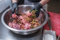 The chef marinates pork meat. Delicious food in the restaurant. Royalty Free Stock Photo