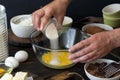 Chef mixes ingredients for making chocolate dessert