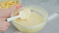 Chef mixing cake batter in a glass bowl. Apple cake preparation process