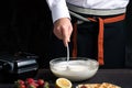 Chef mixing waffle dough in a bowl Royalty Free Stock Photo