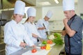 Chef observing the students Royalty Free Stock Photo