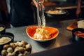 Chef with pan cooking pasta on wooden table Royalty Free Stock Photo