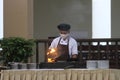 A chef at a Pangandaran beach hotel is cooking with the flambe technique