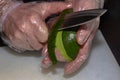 Chef is peeling avocado with sharp japanese knife