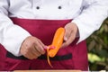 Chef peeling carrots with peeler