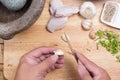 Chef peeling garlic with knife Royalty Free Stock Photo