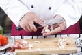 Chef peeling garlic with knife Royalty Free Stock Photo