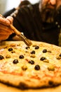 Chef Pizzer Preparing fresh Pizza for Serving. Restaurant Waiter at Work Royalty Free Stock Photo