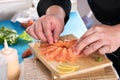 Chef plating up raw salmon for sashimi