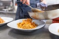 Chef plating up seafood pasta