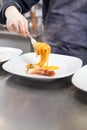 Chef plating up seafood pasta Royalty Free Stock Photo