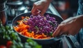 Chef Plating Vibrant Red Cabbage Salad with Fresh Ingredients in Home Kitchen Setting Royalty Free Stock Photo