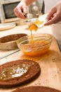 Chef pouring apricot jam to glass bowl Royalty Free Stock Photo