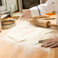 Chef pouring flour dough and rolling pin