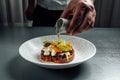 Chef pouring olive oil over Bruschetta with tomato and mozzarella cheese Royalty Free Stock Photo