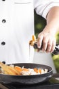 Chef pouring shoyu sauce to the pan for cooking Japanese pork cu