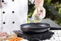 Chef pouring vegetable oil to the pan