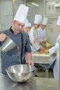 Chef pouring water into bowl Royalty Free Stock Photo