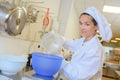 Chef pouring water from jug into bowl Royalty Free Stock Photo