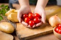 Chef prepare fresh tomatoes and potato on chopping board for making a Vegetable salad at Kitchen Royalty Free Stock Photo