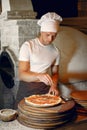 Chef in a white uniform prepare a pizzaa Royalty Free Stock Photo