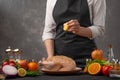 Chef prepares chicken for baking, pour over lemon juice. Preparing for the holidays. Day. Thanksgiving, Christmas or New Year.