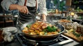 chef prepares delicious meal with chicken and vegetables in restaurant kitchen Royalty Free Stock Photo