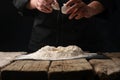 The chef prepares the dough by breaking an egg, working with flour. Culinary recipes Royalty Free Stock Photo