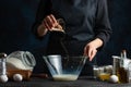 Chef prepares dough by pouring out shakes, baked goods, homemade recipes and cooking Royalty Free Stock Photo