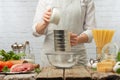 The chef prepares the dough working with flour  baking pasta or pizza  bread. On the background of kerpichnaya light hay. Recipe Royalty Free Stock Photo