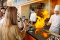 The chef prepares food in front of the visitors in the restaurant Royalty Free Stock Photo