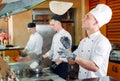 The chef prepares food in front of the visitors in the restaurant Royalty Free Stock Photo