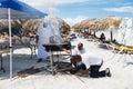 Chef prepares a giant seafood paella on beach Varadero near sunbathing tourists