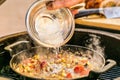 Chef prepares ingredients for bulgur on the grill