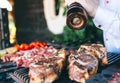 The Chef prepares meat on the barbecue. Royalty Free Stock Photo