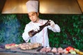 The Chef prepares meat on the barbecue. Royalty Free Stock Photo