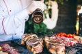 The Chef prepares meat on the barbecue. Royalty Free Stock Photo