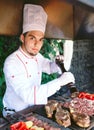 The Chef prepares meat on the barbecue. Royalty Free Stock Photo