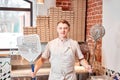 The chef prepares pizza in a neapolitan pizzeria. Cook in a apron in the kitchen with a shovel in his hands. boxes for Royalty Free Stock Photo